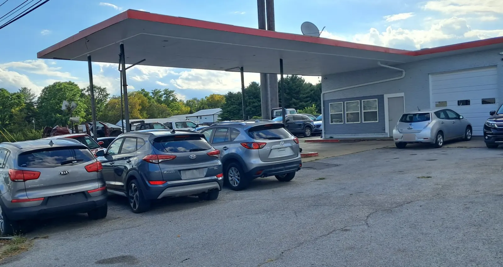 Three crossovers lined up under the canopy at CM Auto Sales.
