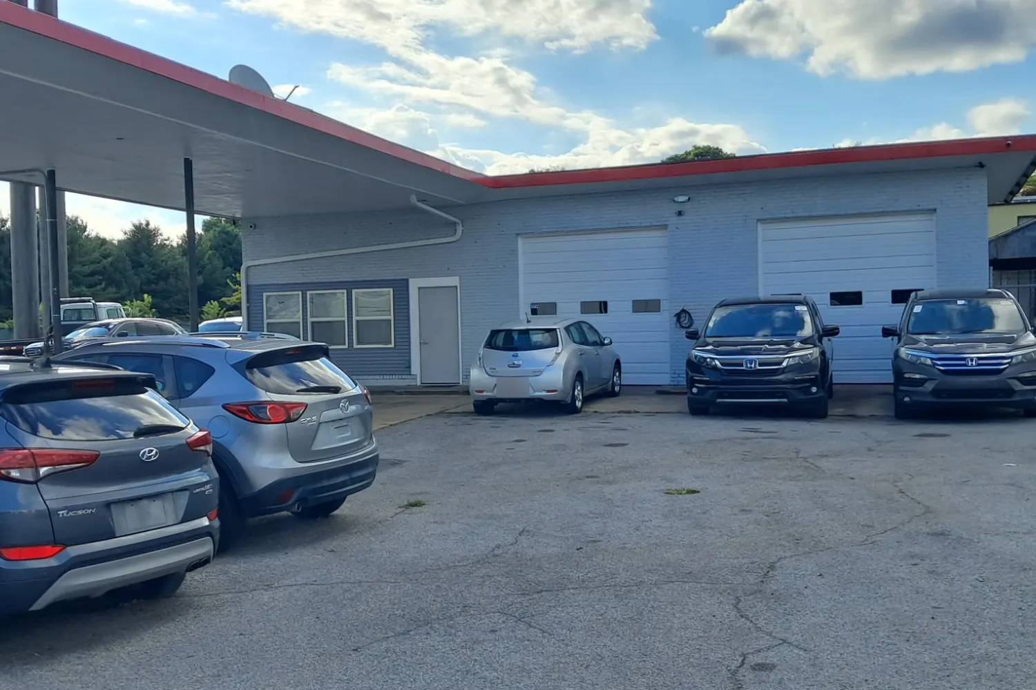 The CM Auto Sales lot in Hagerstown, with vehicles parked in front of the service bays and canopy.